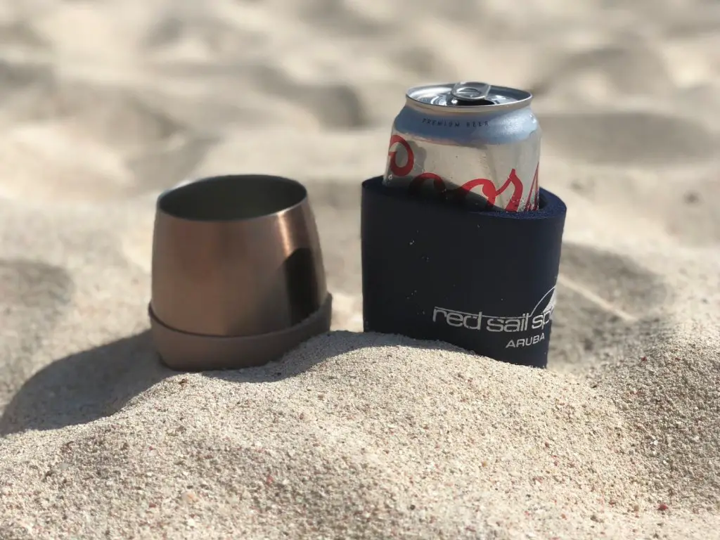 cup and beer in the sand at boca grandi kite surfing beach