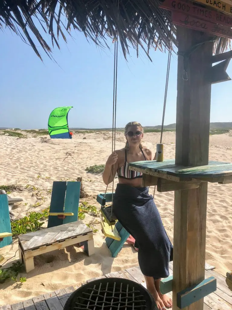 girl sitting on swing at boca grandi kite beach