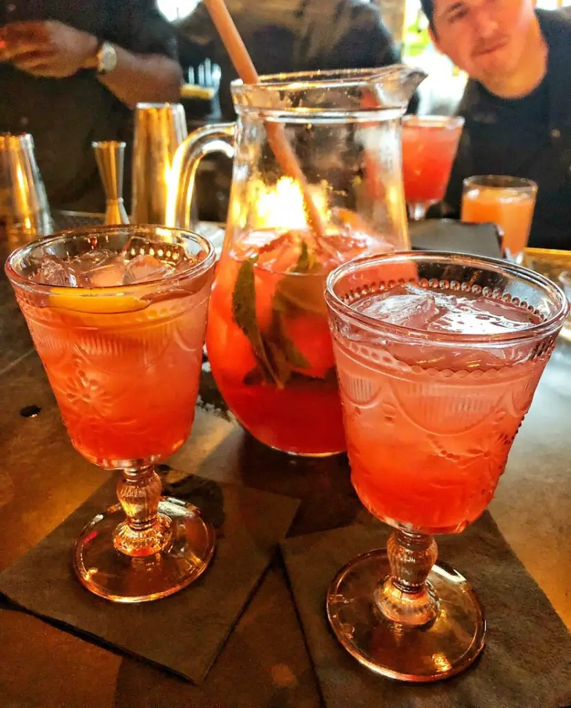 two glasses and a pitcher of punch at succotash
