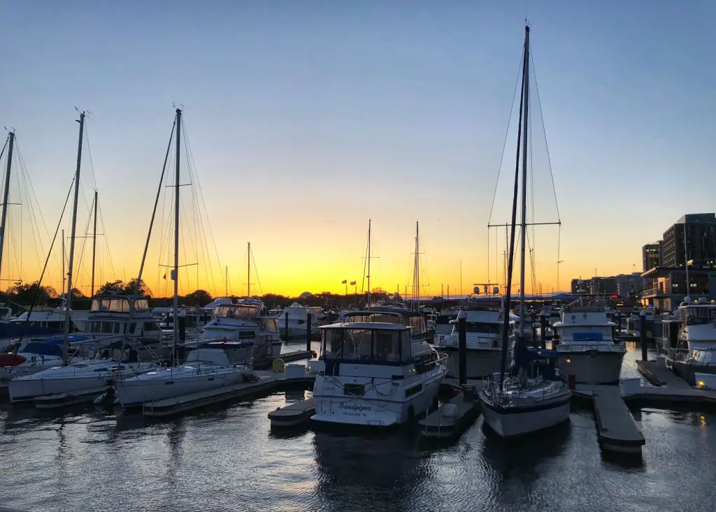 sunset behind the boats in the harbor at the wharf, dc