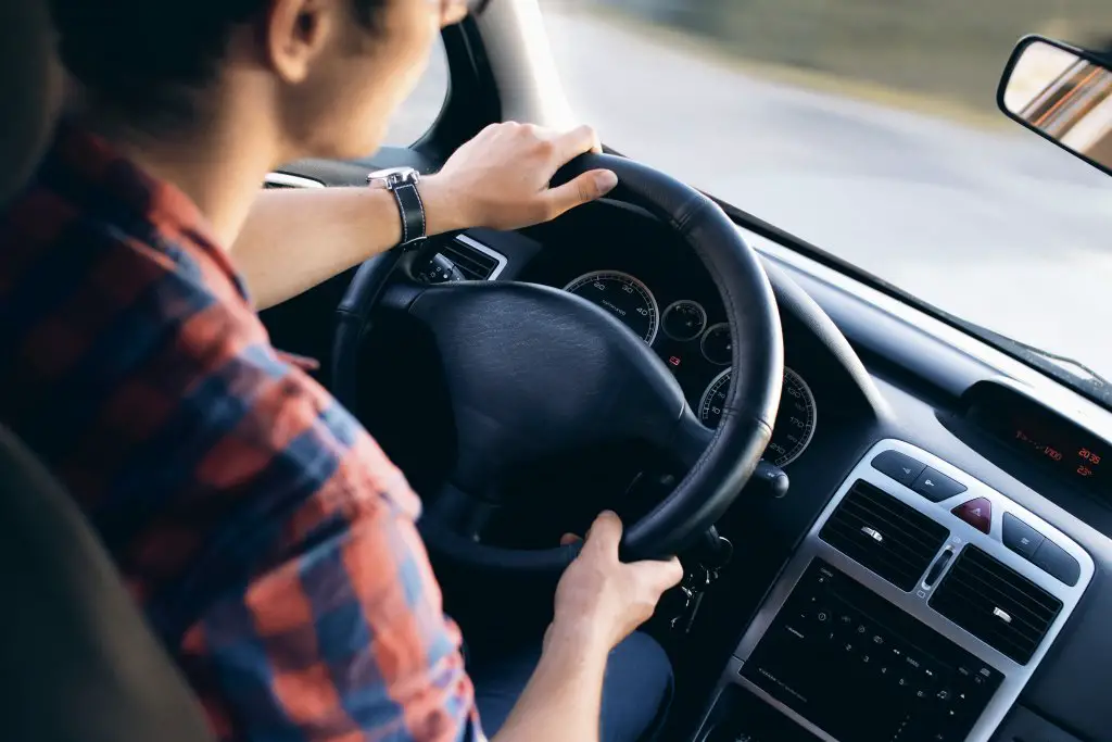 woman driving her used car to save to travel 