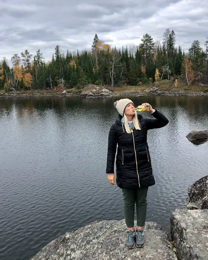 girl drinking beer in the woods