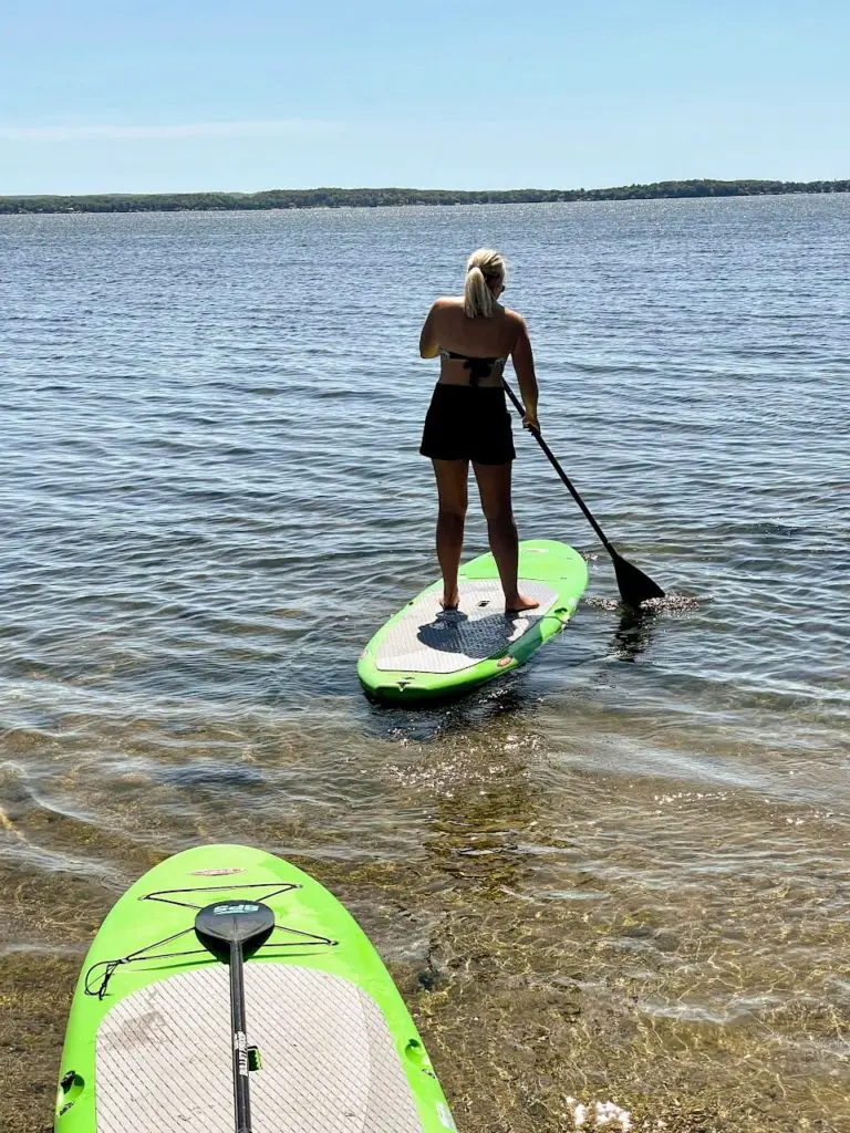 girl paddleboarding in detroit lakes minnesota